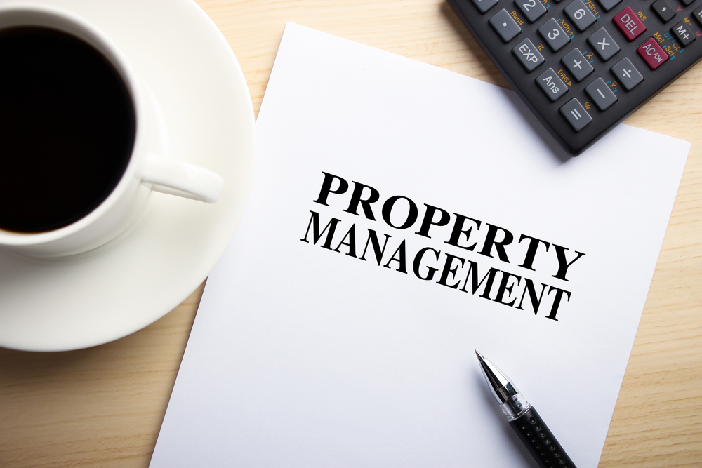 Text Property Management is on the white paper with coffee, calculator and ball pen aside.